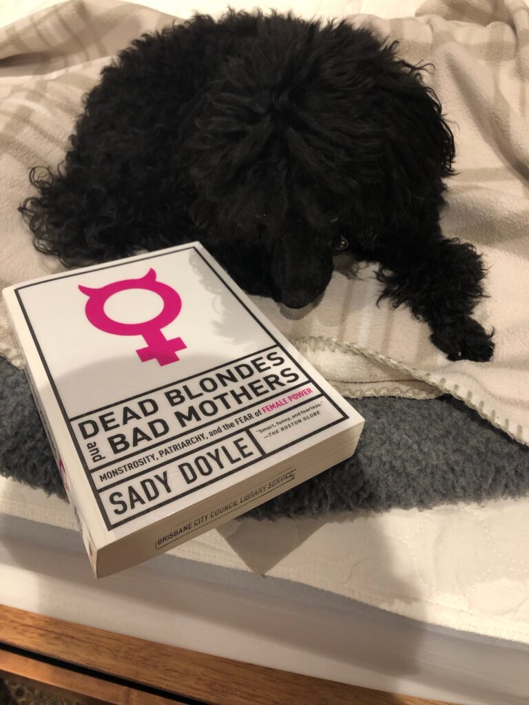 My dog Rosie with the book Dead Blondes and Bad Mothers by Sady Doyle